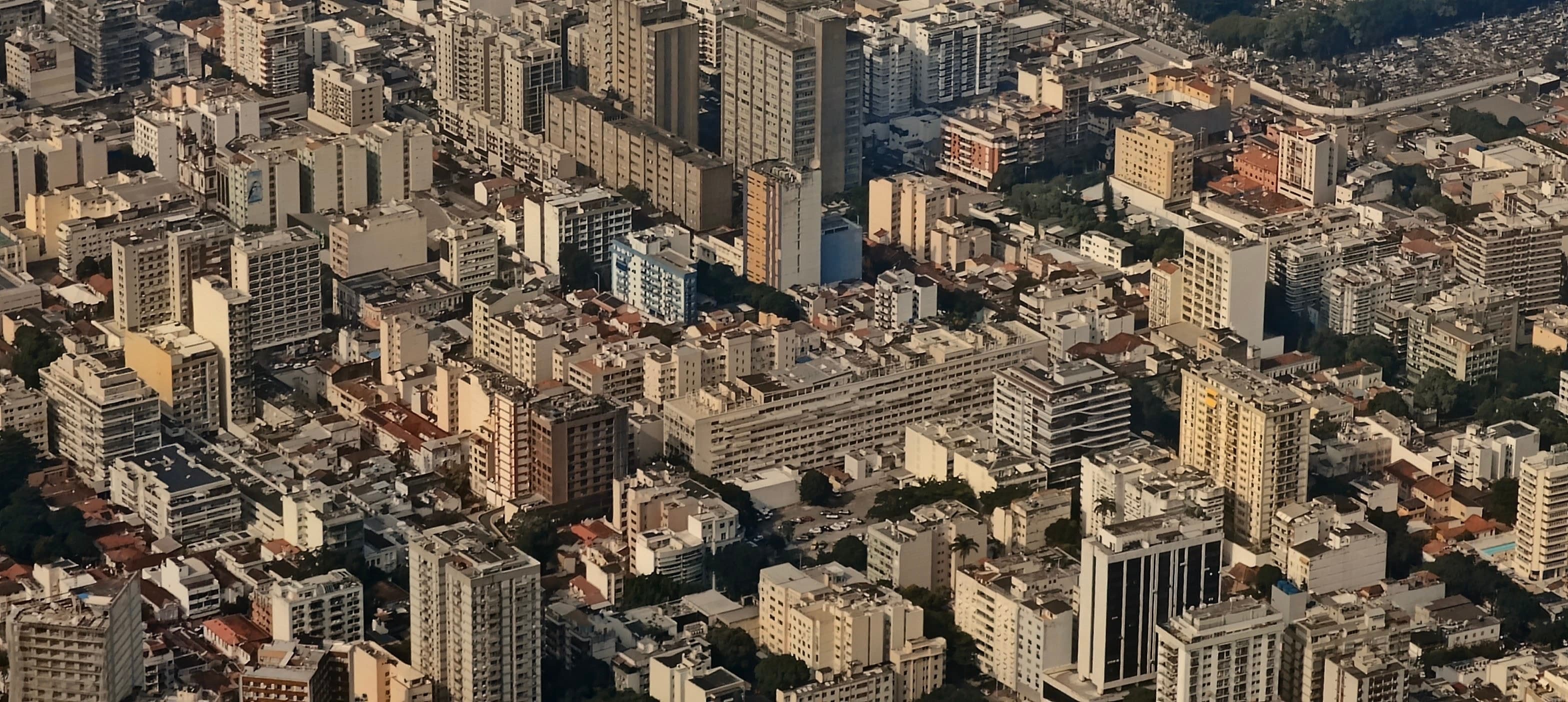 Dense blocks, towers and streets of Rio de Janeiro seen steeply from the Corcovado viewpoint.