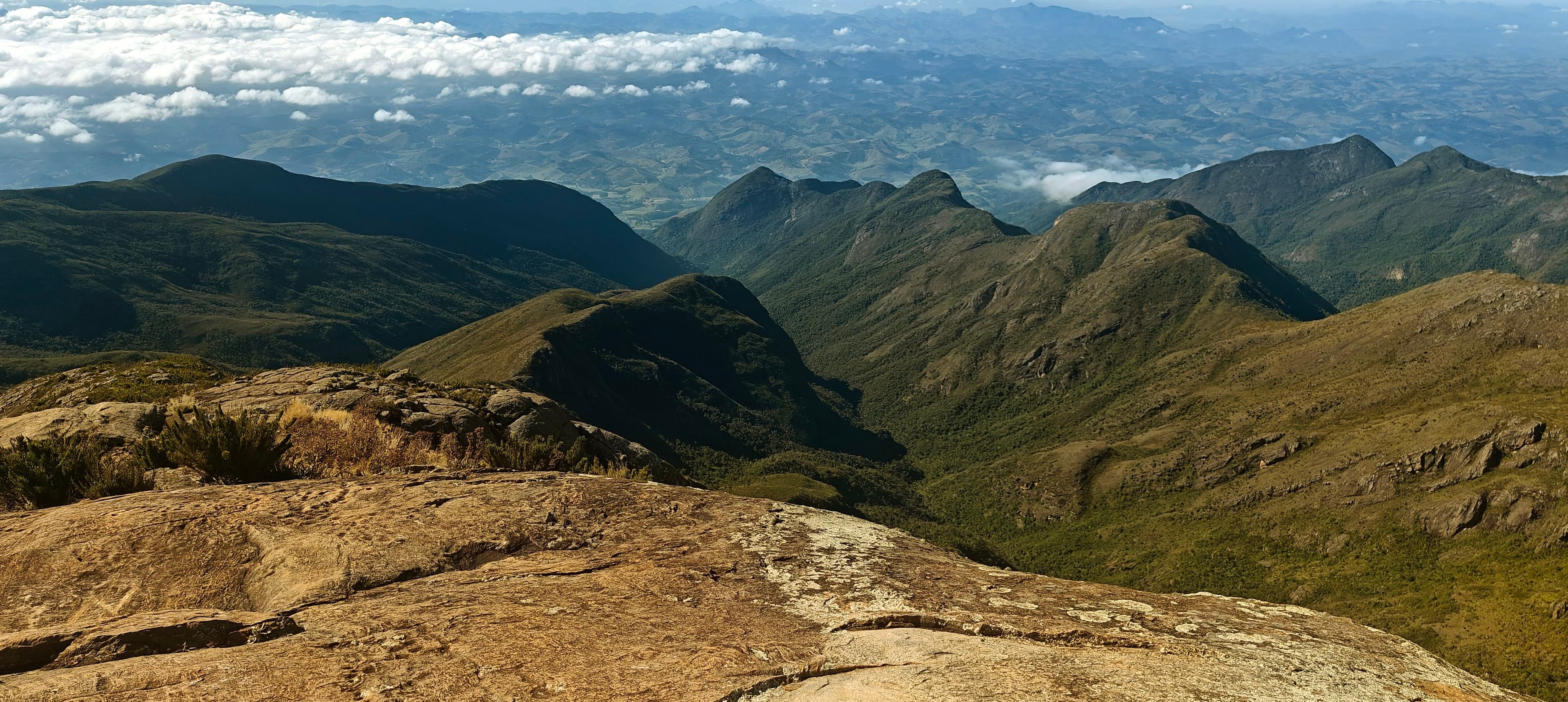 Layered green and rocky ridges extending from Pico da Bandeira into the distance.