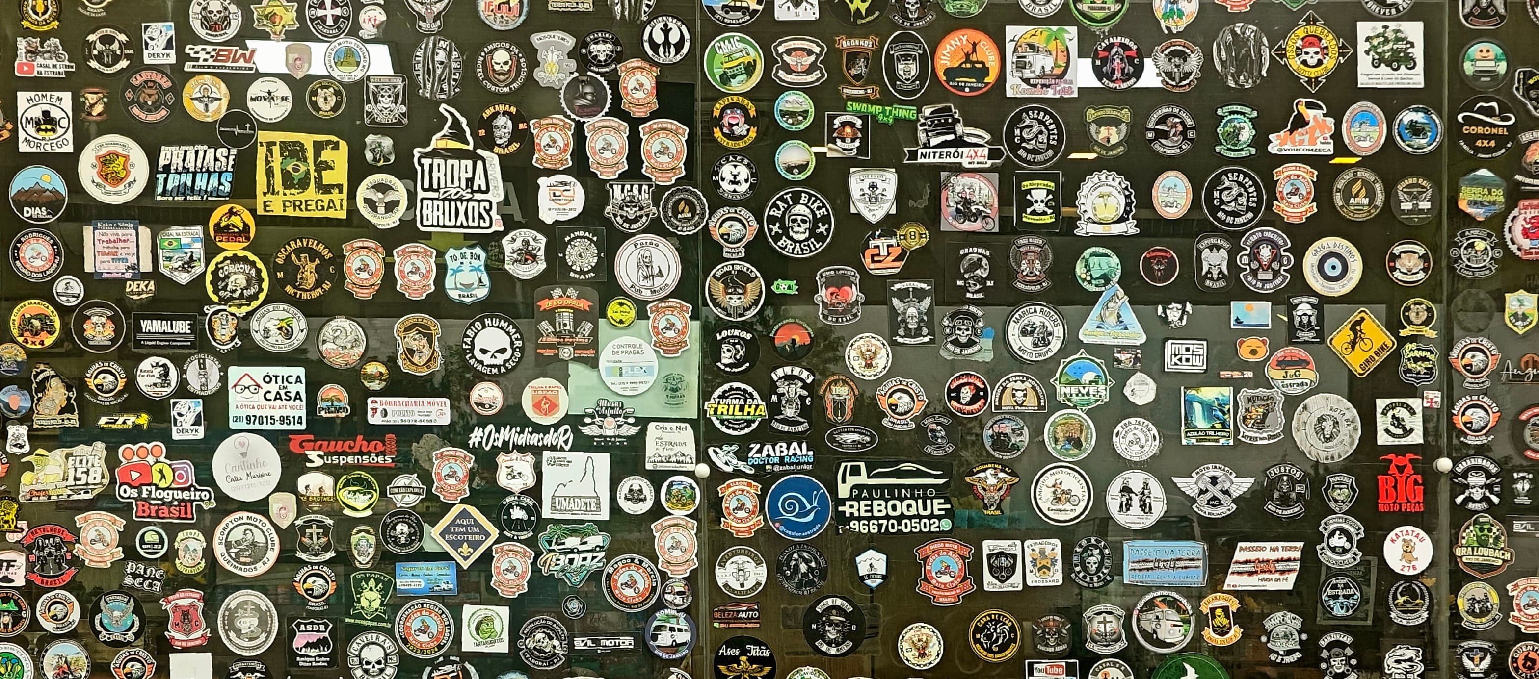 Wall densely covered with hundreds of travel, outdoor and club stickers.