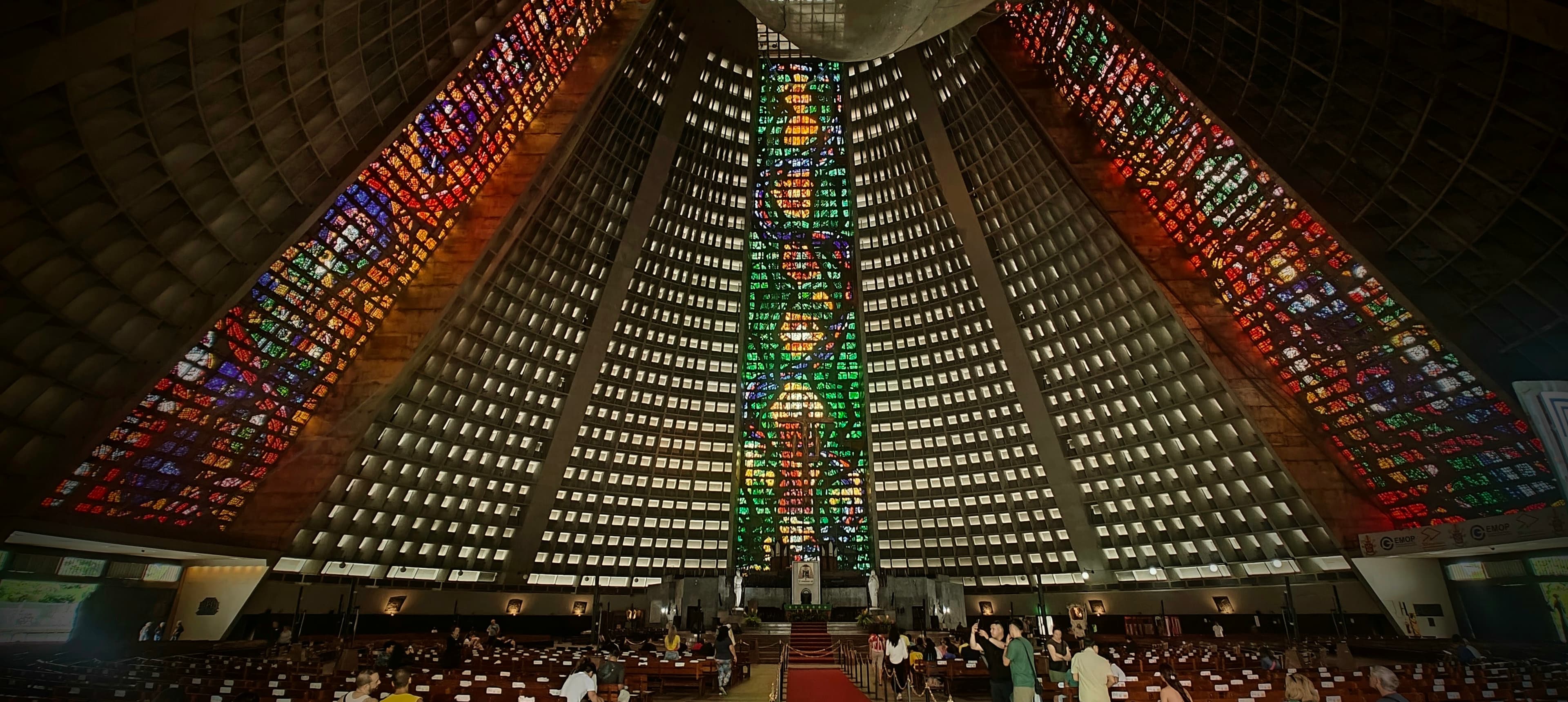 Tall stained-glass panels rise through the dark interior of Rio’s Metropolitan Cathedral.