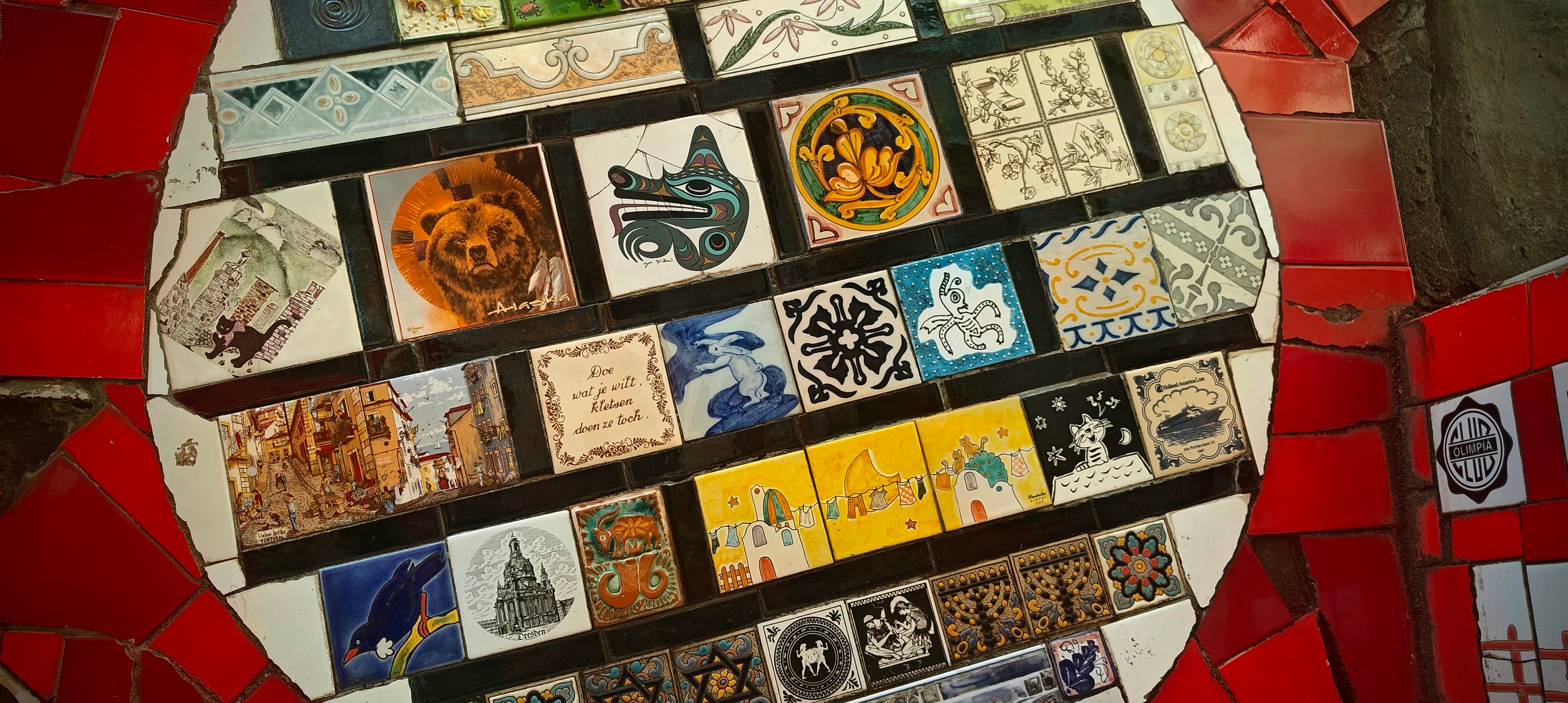 A close view shows many small illustrated ceramic tiles on Escadaria Selarón.