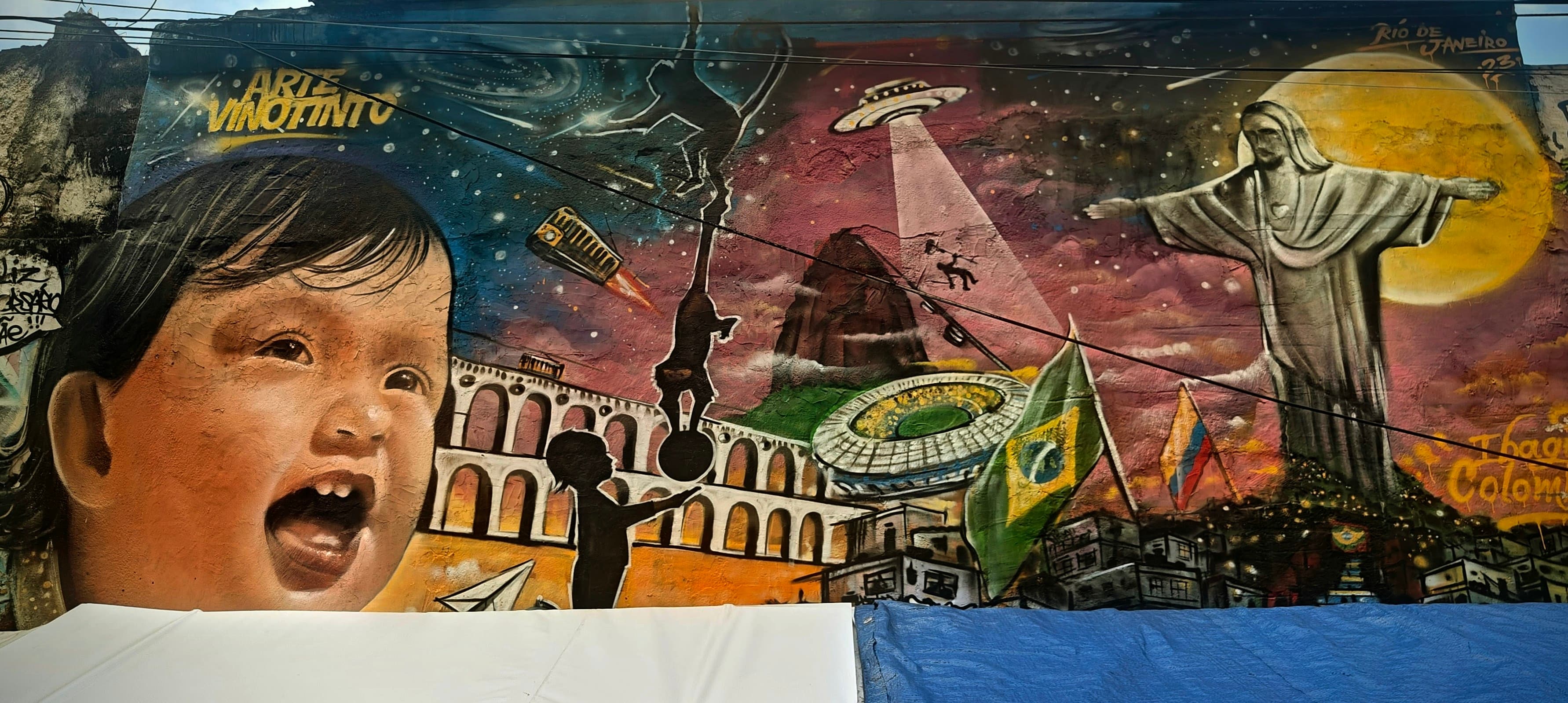 A colourful mural combines a child, Christ the Redeemer, arches and football imagery.